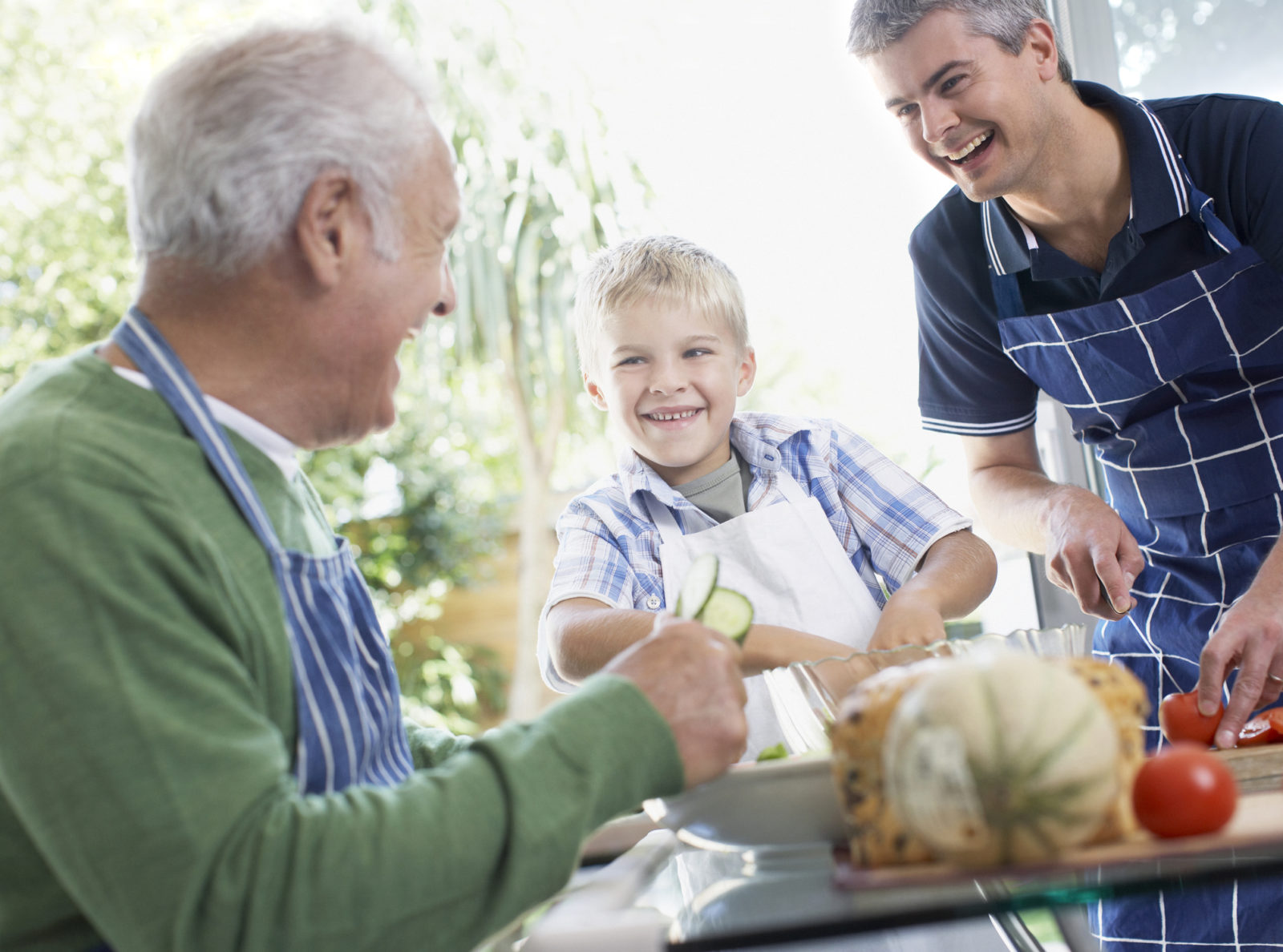 Grandfather, father and son preparing healthy meal
