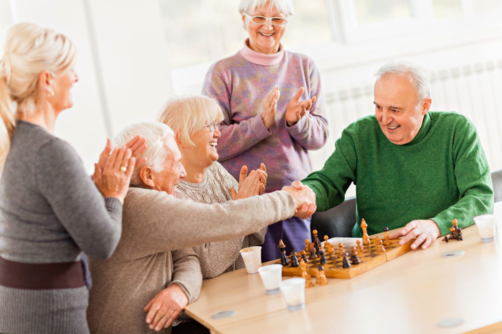 Close up of a senior people playing chess in nursing home