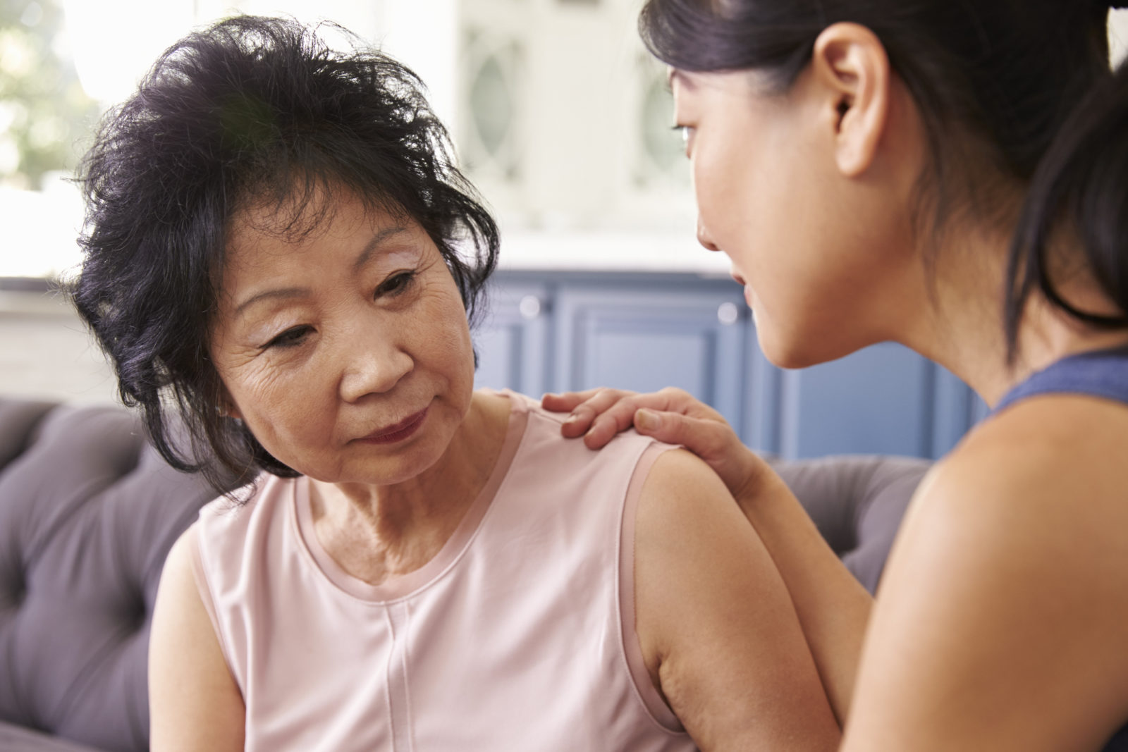 Adult Daughter Talking To Depressed Mother At Home