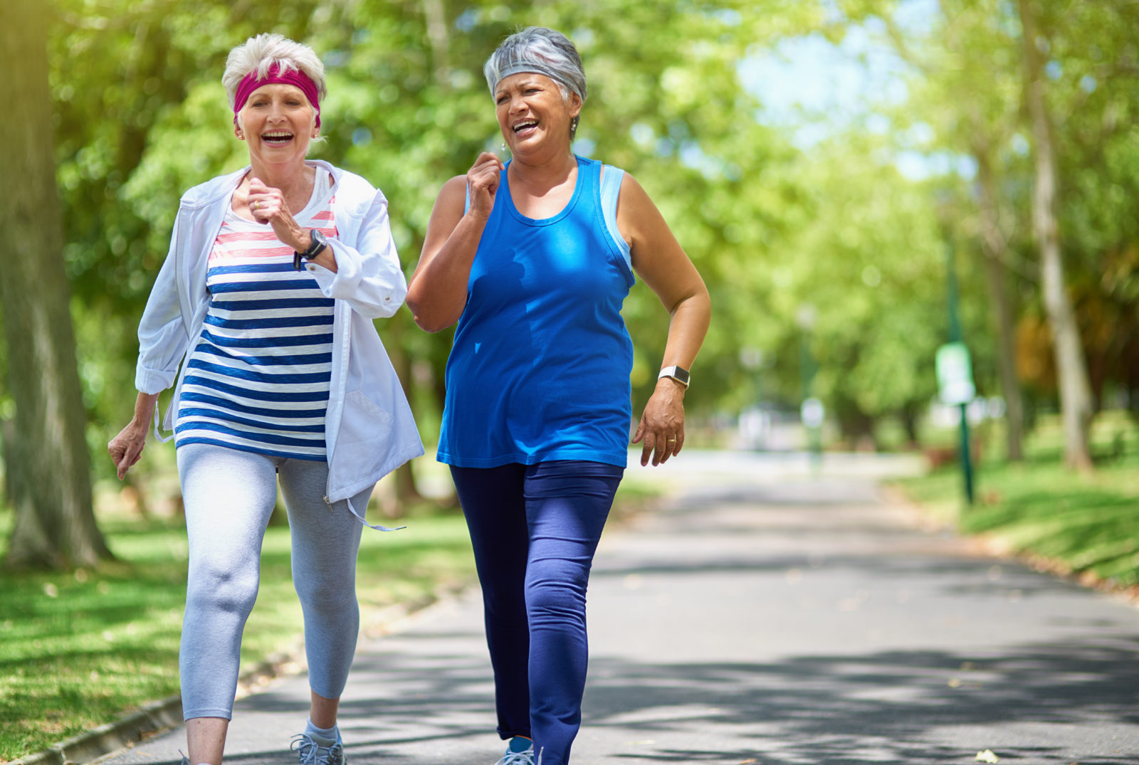 two elderly friends enjoying a run together outdoors