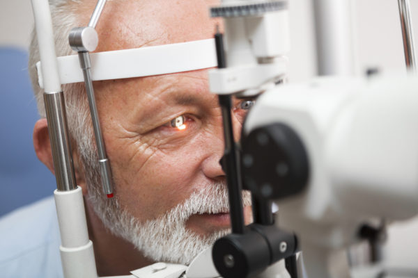 senior man getting eye exam