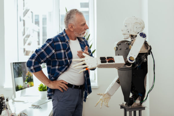elderly man with robot